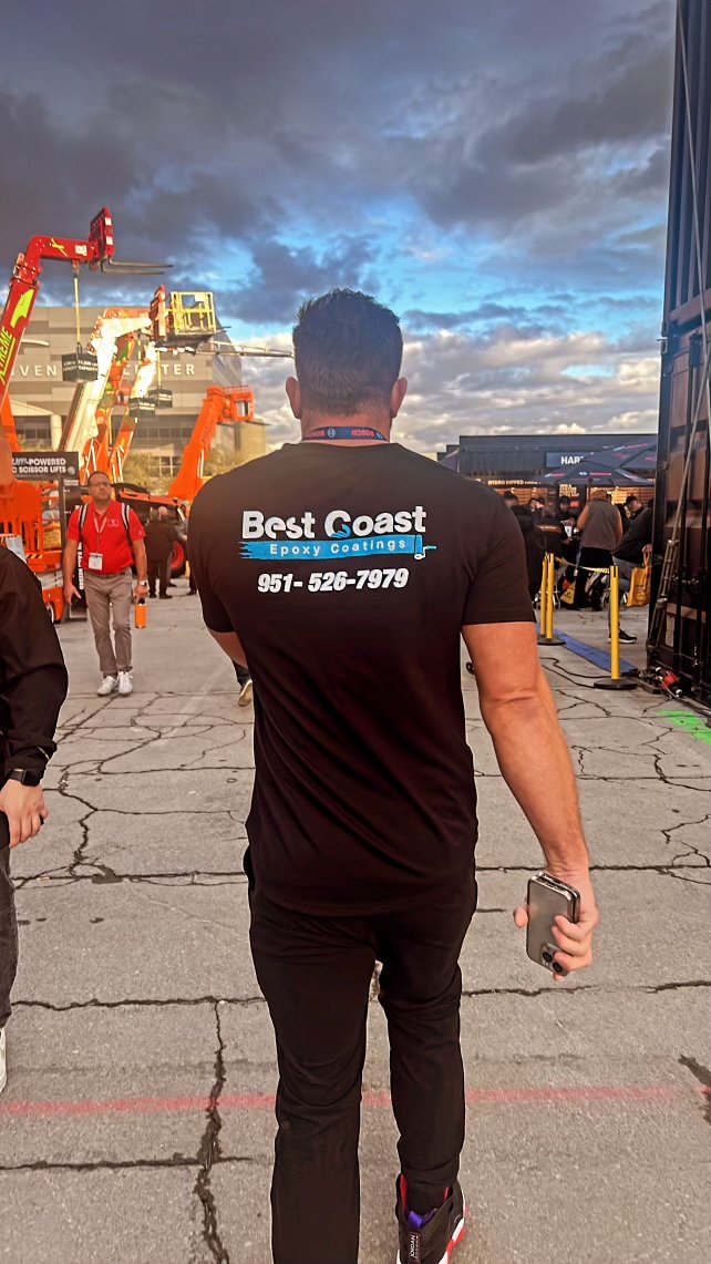 Ryan Pepple, founder of Best Coast Epoxy Coatings, in a company shirt walking a job site