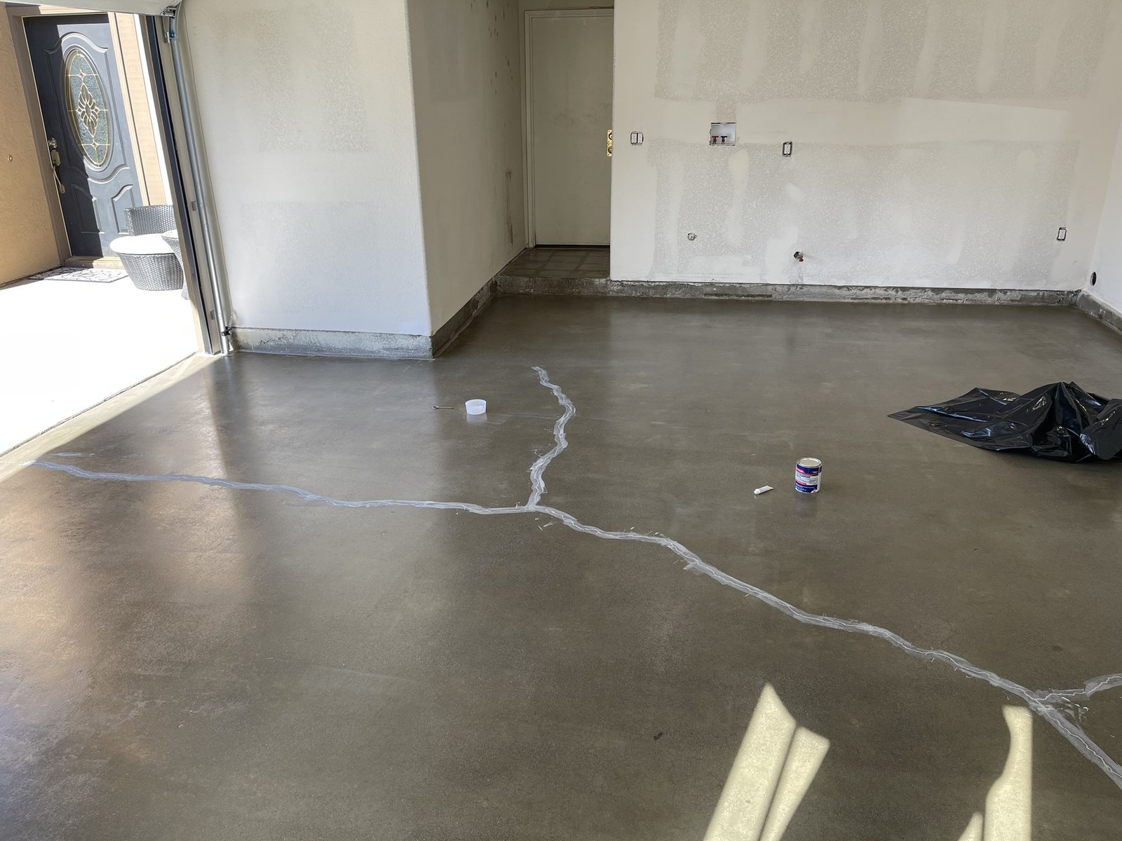 Diamond-ground garage slab with cracks filled and repaired before the floor coating goes down